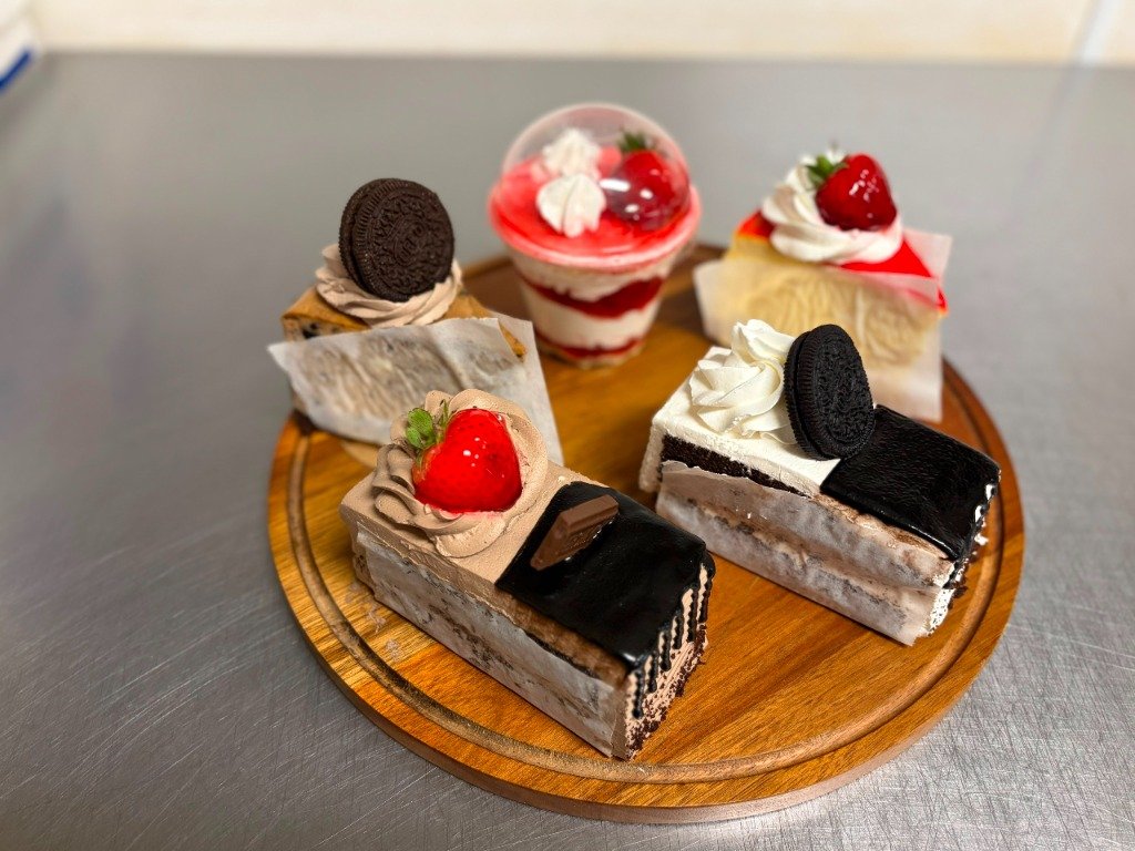 Slice portions of gourmet cakes at El Trigal Orange NJ